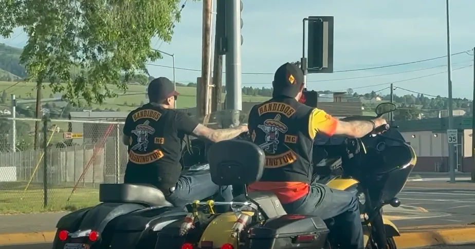 A motorcycle rider traveling on a Montana highway during summer traffic