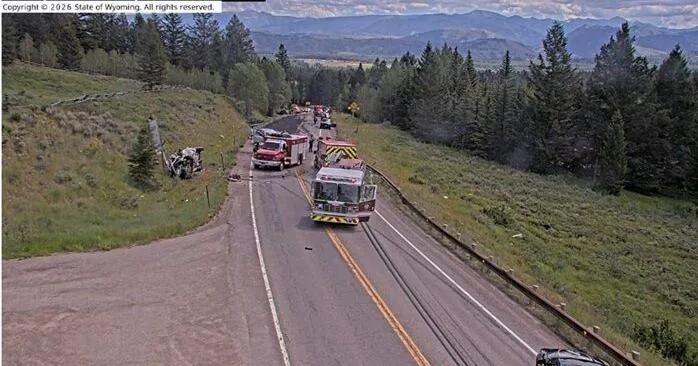 Emergency response vehicles on a mountain highway after a fatal multi-vehicle crash
